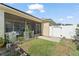 Spacious backyard featuring a screened-in porch, white fencing, and mature landscaping at 12936 Freeman St, Windermere, FL 34786