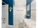 Bright bathroom with blue accent wall, white shower, and ceramic tile flooring at 12936 Freeman St, Windermere, FL 34786