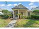 Charming single-story home with a covered porch, columns, green lawn, and manicured landscaping at 12936 Freeman St, Windermere, FL 34786