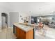 The kitchen features wooden cabinets and granite countertops with an open concept to the living room and dining area at 12936 Freeman St, Windermere, FL 34786