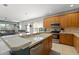 Bright kitchen featuring wooden cabinets, a stainless-steel oven, and countertops with an open view to the living area at 12936 Freeman St, Windermere, FL 34786