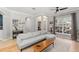 Open-concept living room with hardwood floors, neutral paint, stylish furniture, and lots of natural light at 12936 Freeman St, Windermere, FL 34786