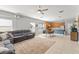 Open concept living space features an oversized sectional sofa, and seamless flow to kitchen and dining area at 12936 Freeman St, Windermere, FL 34786