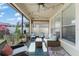 Inviting screened porch with comfortable seating, a ceiling fan, and views of the lush backyard at 12936 Freeman St, Windermere, FL 34786