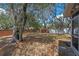 Backyard with mature oak trees and landscaping creating a relaxing outdoor space and adjacent screened in porch at 130 Kristi Ann Ct, Winter Springs, FL 32708