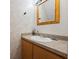 Cozy half bathroom with a pedestal sink, decorative mirror, and charming wallpaper at 130 Kristi Ann Ct, Winter Springs, FL 32708