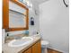Bathroom featuring a single vanity, framed mirror, and toilet, providing a functional space at 130 Kristi Ann Ct, Winter Springs, FL 32708
