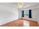 Bedroom with hardwood floors, ceiling fan, and window with blue curtains at 130 Kristi Ann Ct, Winter Springs, FL 32708