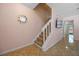 Welcoming entryway featuring a staircase, pink walls, tile flooring and an eye-catching decorative mirror at 130 Kristi Ann Ct, Winter Springs, FL 32708