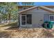 The back of the home features a screened in porch, and mature landscaping at 130 Kristi Ann Ct, Winter Springs, FL 32708