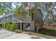 A lovely townhouse showcases a tidy entrance, garden beds, nearby parking, and a touch of classic charm at 130 Kristi Ann Ct, Winter Springs, FL 32708