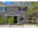 Charming two-story townhome featuring a neutral color, black shutters, and well-maintained landscaping at 130 Kristi Ann Ct, Winter Springs, FL 32708