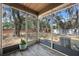 A screened porch with wood-look flooring, plants and a view of the backyard invites relaxation at 130 Kristi Ann Ct, Winter Springs, FL 32708