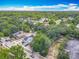 Aerial view showing the house and neighborhood among mature trees at 1314 S Mellonville Ave, Sanford, FL 32771
