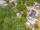 Aerial view showing a spacious lot with mature trees and outdoor recreational space at 1314 S Mellonville Ave, Sanford, FL 32771