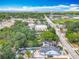Expansive aerial view of a property featuring a fenced yard with a pool and mature trees at 1314 S Mellonville Ave, Sanford, FL 32771