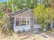 Charming home with mature landscaping, pink flowers and a screened porch at 1314 S Mellonville Ave, Sanford, FL 32771