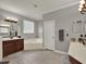 Bathroom with double vanities, a soaking tub, and crown molding at 14315 Letham Grange Ct, Orlando, FL 32828