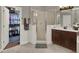 This bathroom features a tile floor, modern shower, wooden cabinet, and walk-in closet at 14315 Letham Grange Ct, Orlando, FL 32828