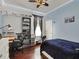 This bedroom has hardwood floors, a blue accent, and a large shelving unit at 14315 Letham Grange Ct, Orlando, FL 32828