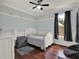 This cozy bedroom features wood floors, natural light, and soft blue walls at 14315 Letham Grange Ct, Orlando, FL 32828