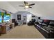 Large bonus room with black leather couch, tv, and entertainment area at 14315 Letham Grange Ct, Orlando, FL 32828