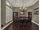 The dining room has hardwood floors and a chandelier above the dining table at 14315 Letham Grange Ct, Orlando, FL 32828