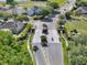Aerial view of a community entrance with lush landscaping, brick features, and a well-maintained road at 14315 Letham Grange Ct, Orlando, FL 32828