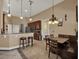 Eat-in kitchen features a breakfast bar, dining area, and modern lighting fixtures at 14315 Letham Grange Ct, Orlando, FL 32828