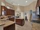 Gourmet kitchen features an island, granite countertops, stainless steel appliances, and plenty of cabinet space at 14315 Letham Grange Ct, Orlando, FL 32828