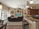 Open-concept living room boasts a fireplace, custom built-ins, and access to the outdoor space at 14315 Letham Grange Ct, Orlando, FL 32828
