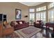 Living room featuring large windows, hardwood flooring, comfortable furniture, and neutral paint at 14315 Letham Grange Ct, Orlando, FL 32828