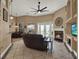 A Gathering room features a ceiling fan, tile flooring, a fireplace, and glass doors to the pool at 14315 Letham Grange Ct, Orlando, FL 32828