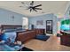 Spacious main bedroom with light blue walls, wood flooring, and a ceiling fan at 14315 Letham Grange Ct, Orlando, FL 32828