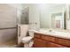 Modern bathroom featuring a glass shower, tiled floors, and wooden cabinetry at 1457 Waukon Cir, Casselberry, FL 32707