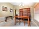 Bright dining area featuring a wooden table and chairs, built-in shelving, and neutral walls at 1457 Waukon Cir, Casselberry, FL 32707