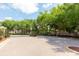 Grand entrance gate welcomes residents into a community with mature trees and manicured landscaping at 1457 Waukon Cir, Casselberry, FL 32707