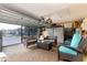 The converted garage includes cozy seating, neutral paint, and a ceiling fan at 1457 Waukon Cir, Casselberry, FL 32707