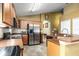 Spacious kitchen with stainless steel appliances, wood cabinetry, and ample counter space at 1457 Waukon Cir, Casselberry, FL 32707