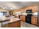 Well-equipped kitchen with wood cabinetry, stainless steel appliances, and a breakfast bar at 1457 Waukon Cir, Casselberry, FL 32707