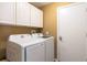 The laundry room features a washer and dryer, overhead cabinets, and a utility door at 1457 Waukon Cir, Casselberry, FL 32707