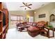 Comfortable living room featuring a leather sectional, a bright window, and a view into the foyer at 1457 Waukon Cir, Casselberry, FL 32707