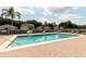 Community pool with a brick deck, surrounded by lush landscaping and comfortable lounge chairs at 1457 Waukon Cir, Casselberry, FL 32707