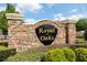 Stone Royal Oaks community sign surrounded by lush greenery adds charm and exclusivity at 1457 Waukon Cir, Casselberry, FL 32707