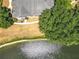 Aerial view of property with expansive backyard, mature tree coverage, and sparkling lake at 163 Villa Di Este Ter # 105, Lake Mary, FL 32746