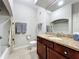 Bathroom featuring granite countertop and shower/tub combination with tile flooring at 163 Villa Di Este Ter # 105, Lake Mary, FL 32746
