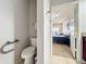 Bathroom with toilet is adjacent to the main bedroom with neutral carpet and walls at 163 Villa Di Este Ter # 105, Lake Mary, FL 32746