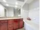 Bathroom features a double vanity with granite counters, a separate tub, and arched doorways at 163 Villa Di Este Ter # 105, Lake Mary, FL 32746