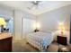 Bedroom with a double closet, ceiling fan, and two side tables with lamps at 163 Villa Di Este Ter # 105, Lake Mary, FL 32746