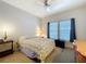 Comfortable bedroom featuring a ceiling fan and double windows that provide natural light at 163 Villa Di Este Ter # 105, Lake Mary, FL 32746